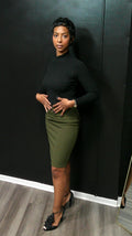 Person lying on a black mat with a green skirt and black top